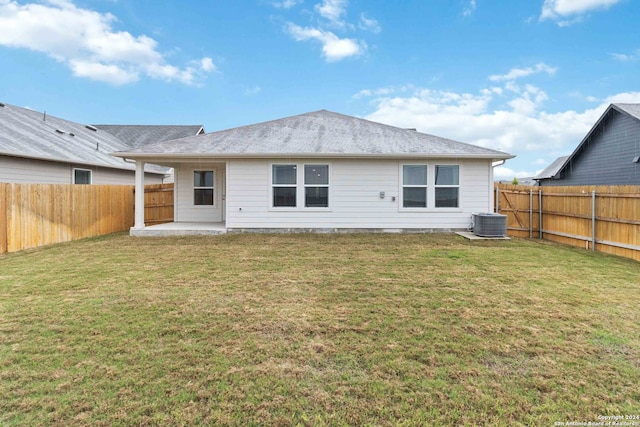 back of property with a yard, a patio, and central AC unit