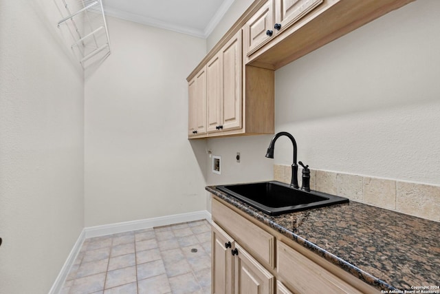 kitchen featuring dark stone counters, light brown cabinets, sink, ornamental molding, and light tile flooring