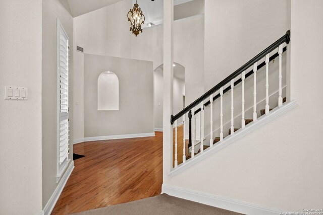 foyer with a notable chandelier and dark wood-type flooring