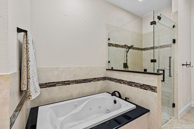 bathroom featuring tile walls, tile floors, and separate shower and tub