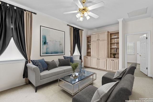 living room with crown molding, light colored carpet, and ceiling fan