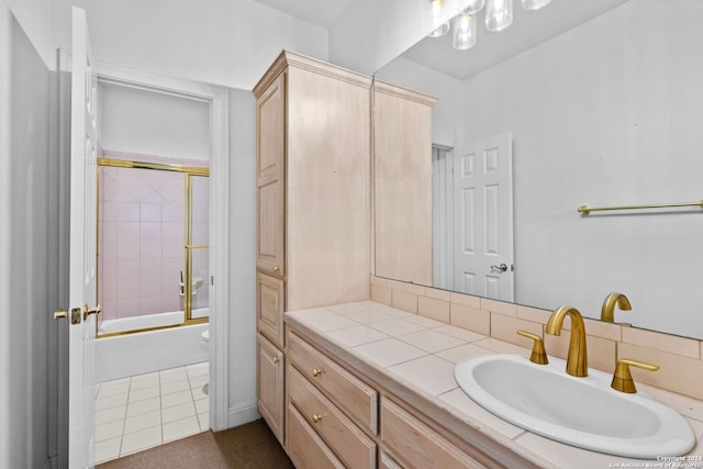 full bathroom featuring tile flooring, enclosed tub / shower combo, toilet, and vanity