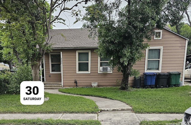 bungalow-style home with a front yard