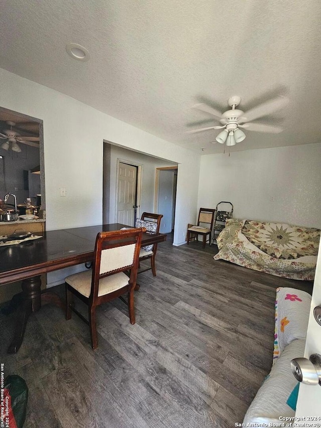 home office featuring ceiling fan, a textured ceiling, and dark wood-type flooring