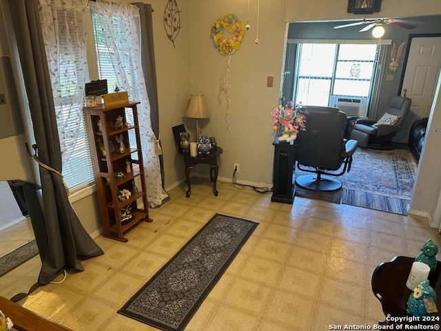 interior space featuring light tile floors and ceiling fan