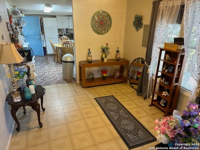 interior space featuring a textured ceiling and light tile flooring