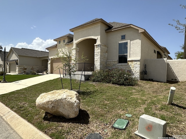 view of front facade with a garage and a front lawn