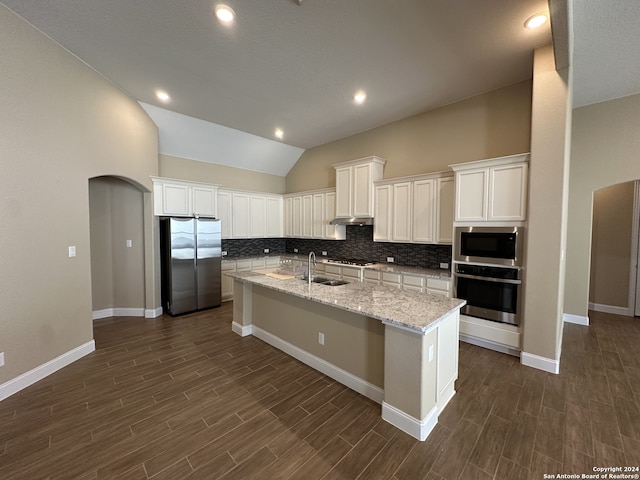 kitchen featuring appliances with stainless steel finishes, a kitchen island with sink, sink, white cabinets, and dark hardwood / wood-style floors