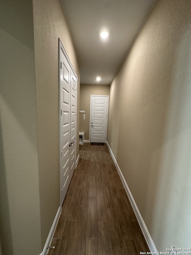 hallway with dark hardwood / wood-style floors