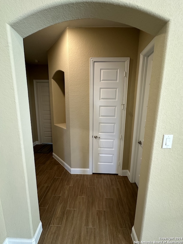 hallway with dark wood-type flooring