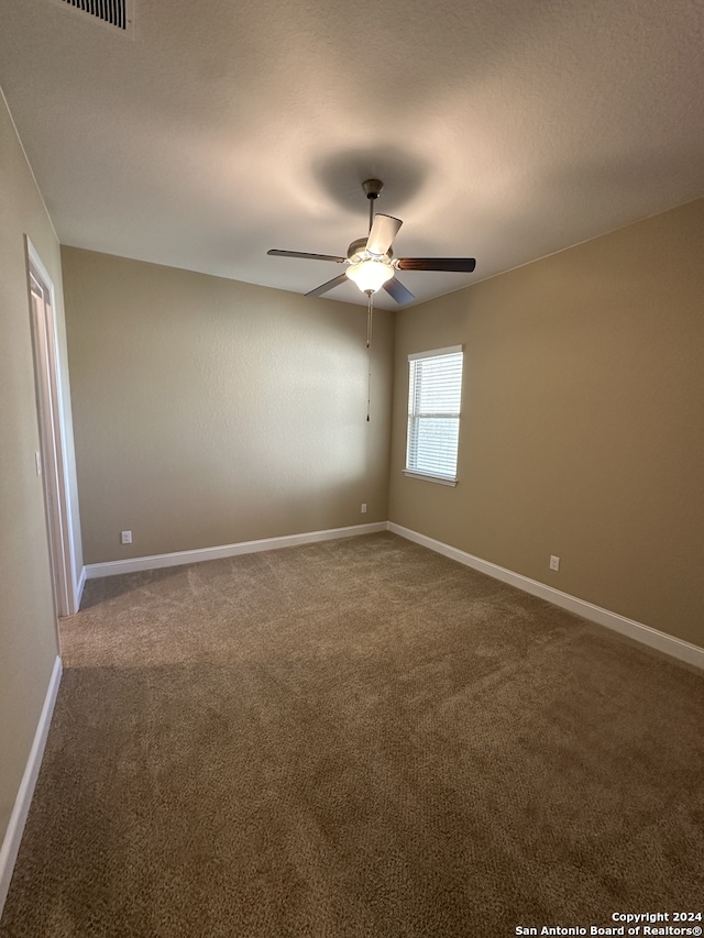 unfurnished room with carpet, a textured ceiling, and ceiling fan