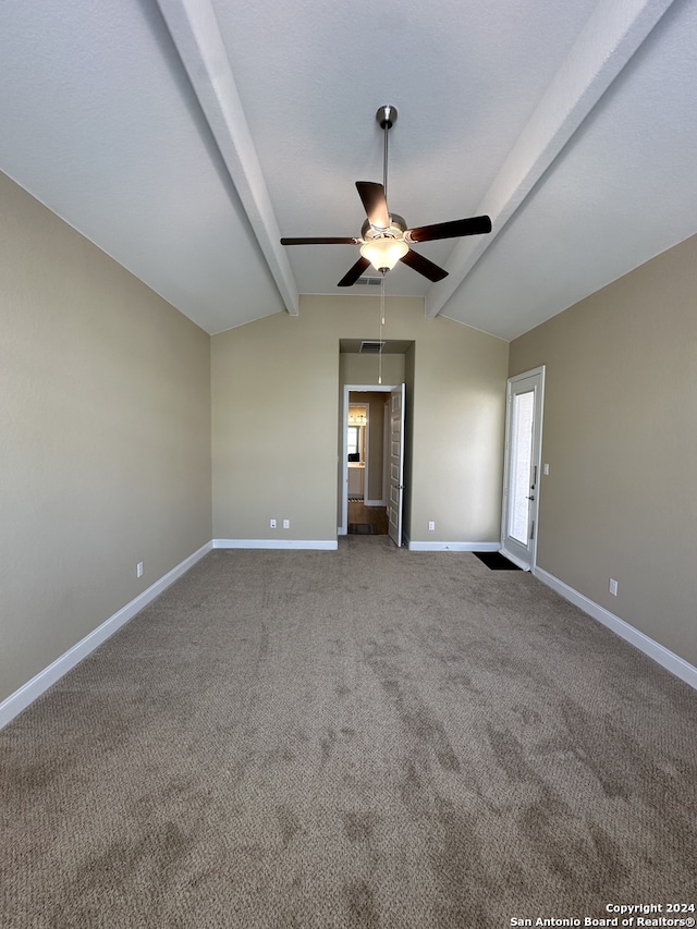 carpeted spare room with ceiling fan and lofted ceiling with beams