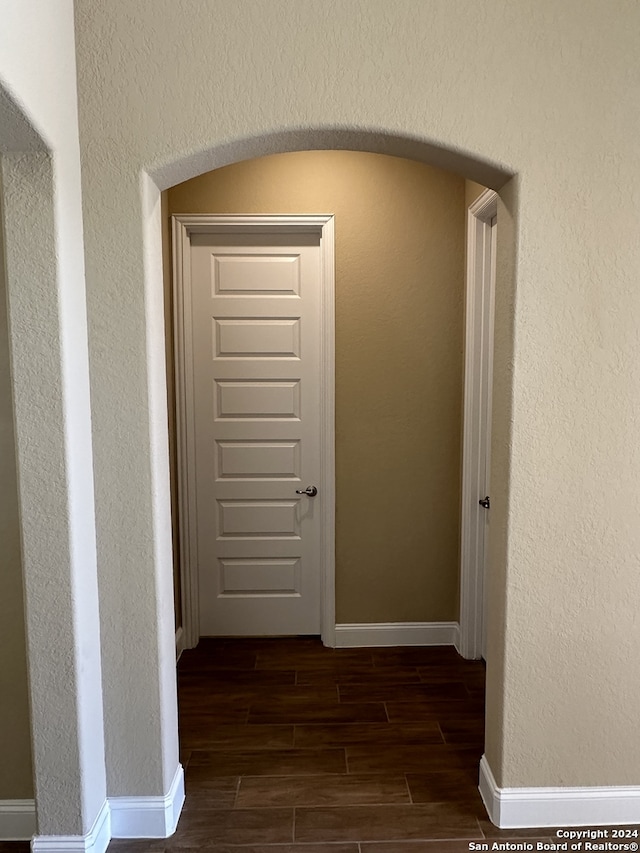 hall with dark hardwood / wood-style floors