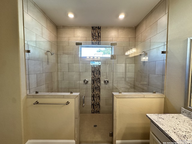 bathroom with vanity and a shower with door