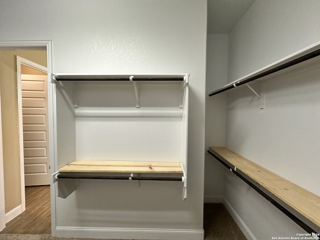 walk in closet featuring dark hardwood / wood-style floors