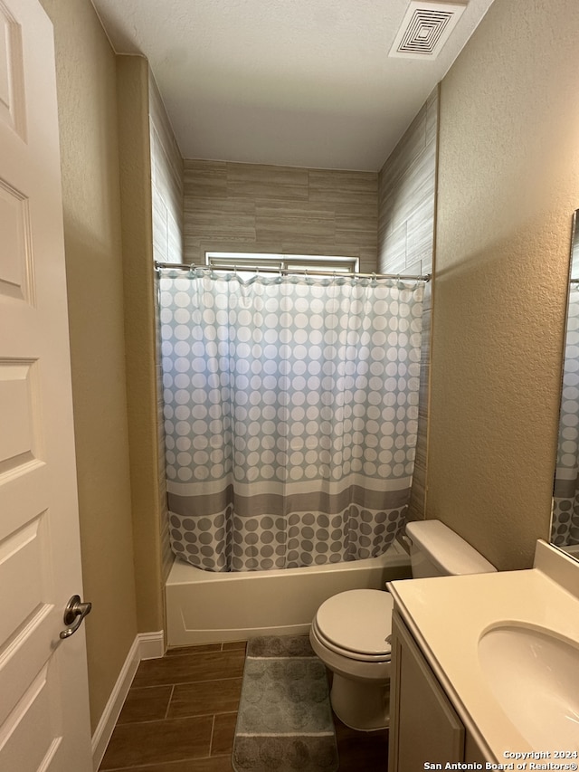 full bathroom featuring hardwood / wood-style flooring, vanity, toilet, and shower / bathtub combination with curtain