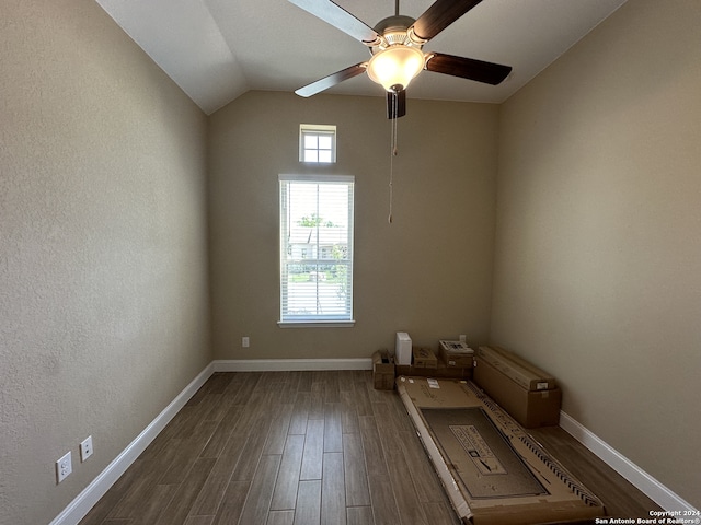 empty room featuring ceiling fan, dark wood-type flooring, and vaulted ceiling