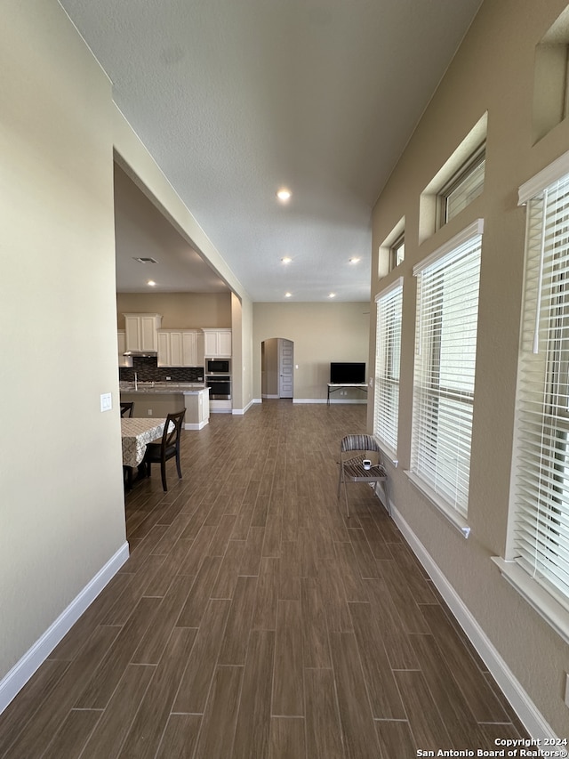 hallway with dark hardwood / wood-style floors