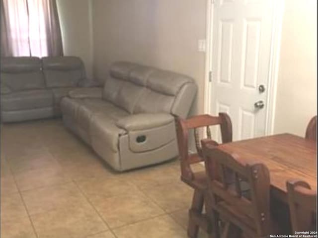 living room featuring light tile floors