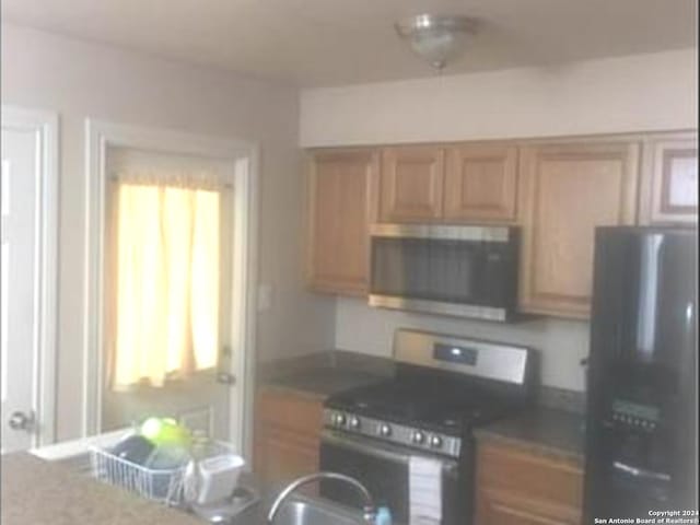 kitchen with range and fridge