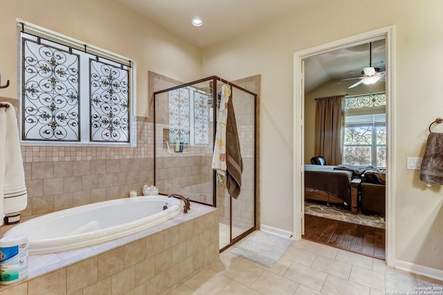 bathroom featuring independent shower and bath, vaulted ceiling, tile floors, and ceiling fan