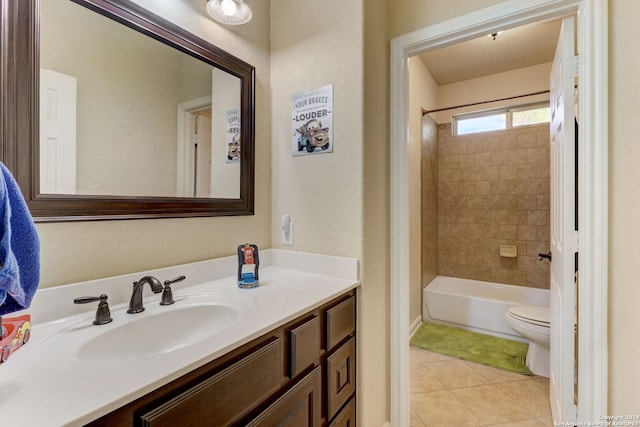 full bathroom featuring tiled shower / bath, toilet, large vanity, and tile floors