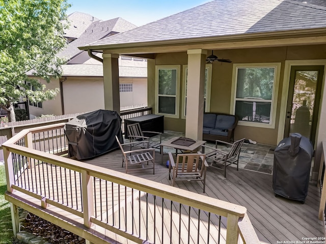 wooden terrace with an outdoor hangout area, grilling area, and ceiling fan