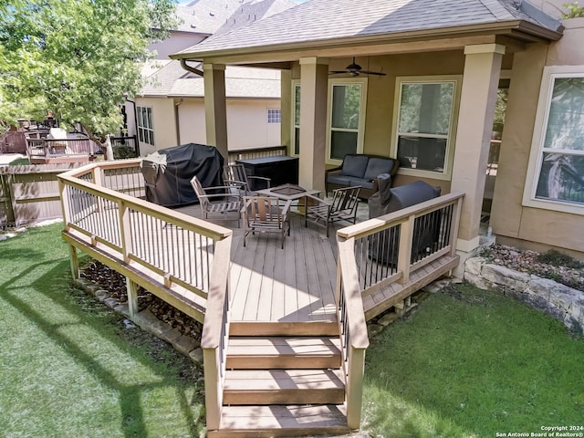 wooden terrace with ceiling fan and a yard