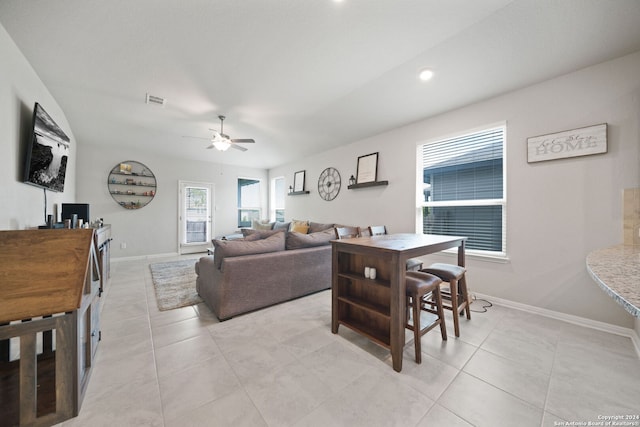 living room with light tile flooring and ceiling fan