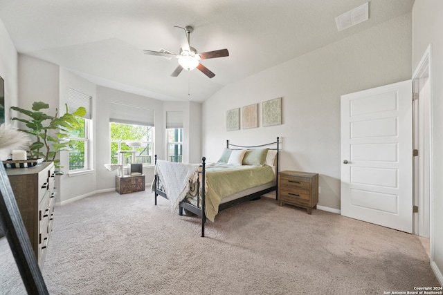 bedroom featuring ceiling fan, light carpet, and vaulted ceiling