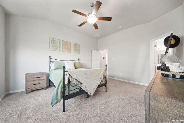 bedroom featuring ceiling fan, light carpet, and vaulted ceiling