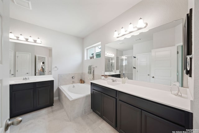 bathroom featuring independent shower and bath, tile floors, and vanity