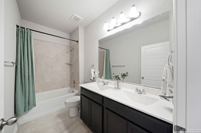 full bathroom with shower / bath combination with curtain, tile floors, toilet, and dual bowl vanity