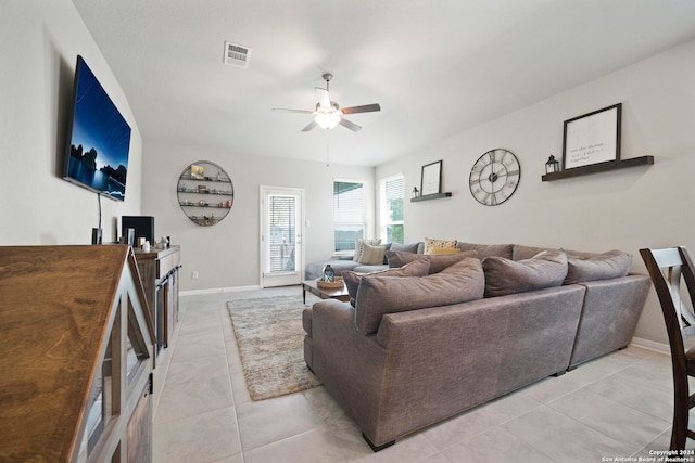 tiled living room with ceiling fan