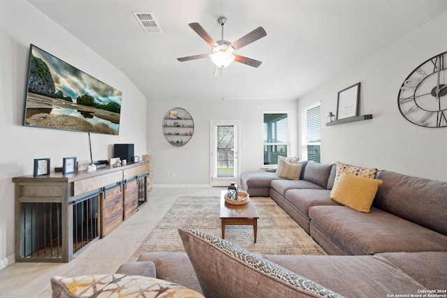 living room with light tile floors and ceiling fan