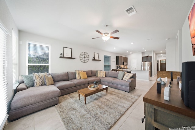 tiled living room with ceiling fan