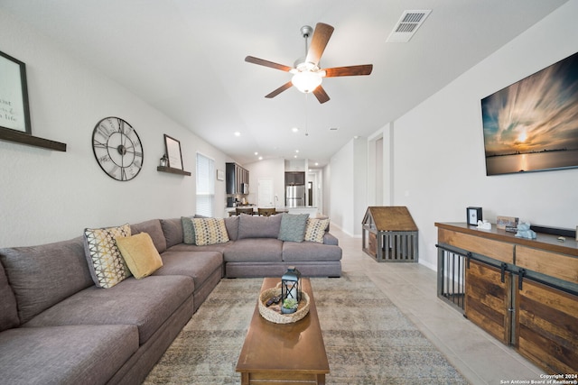 living room with light tile floors and ceiling fan