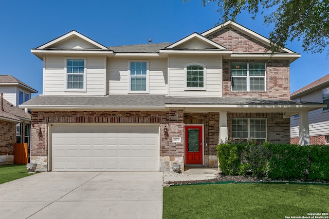 view of front of house featuring a front lawn and a garage