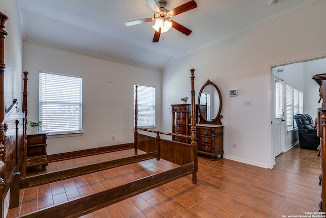 bedroom featuring lofted ceiling, ornamental molding, ceiling fan, and light wood-type flooring