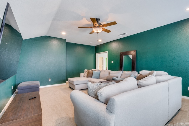 carpeted living room with ceiling fan and lofted ceiling