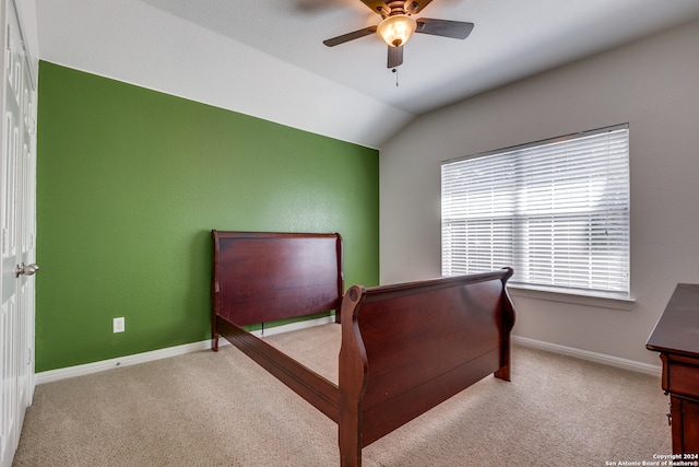 carpeted bedroom featuring lofted ceiling and ceiling fan