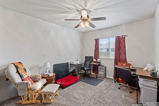 carpeted home office with a textured ceiling and ceiling fan