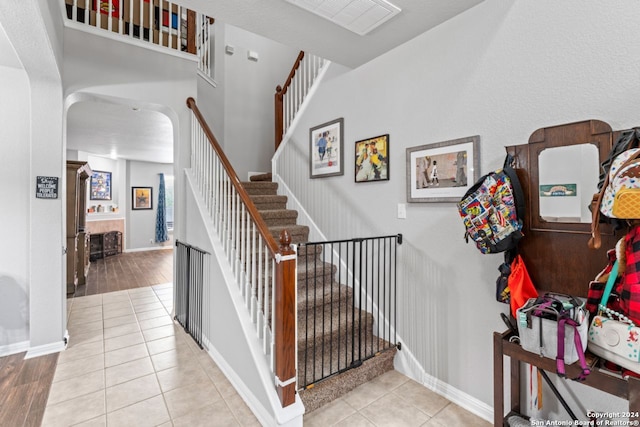 stairway with light tile floors