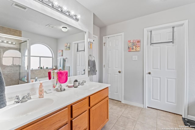 bathroom featuring tile flooring and double vanity