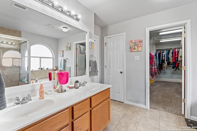 bathroom featuring dual bowl vanity and tile flooring