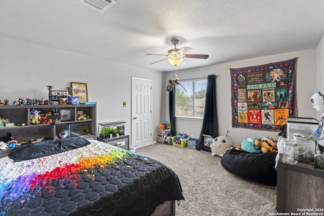 carpeted bedroom featuring a textured ceiling and ceiling fan