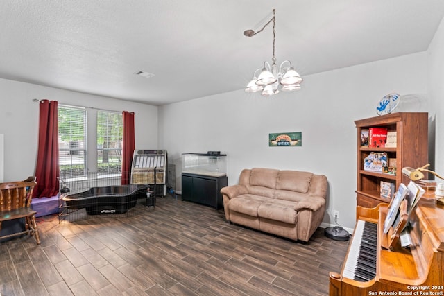 interior space featuring dark hardwood / wood-style flooring, a textured ceiling, and a chandelier