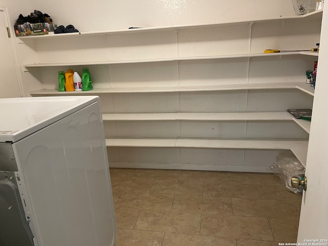 laundry room featuring washer / clothes dryer and light tile floors