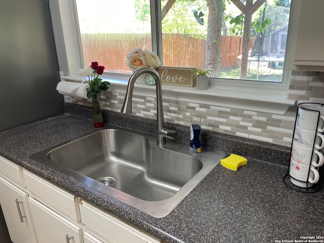 interior details featuring backsplash and vanity