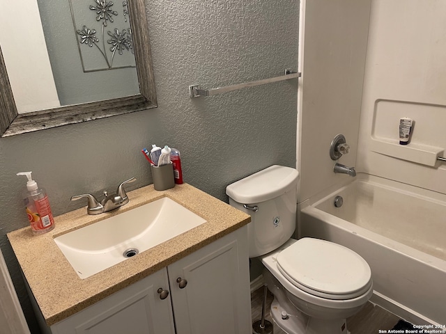 full bathroom with washtub / shower combination, large vanity, and toilet